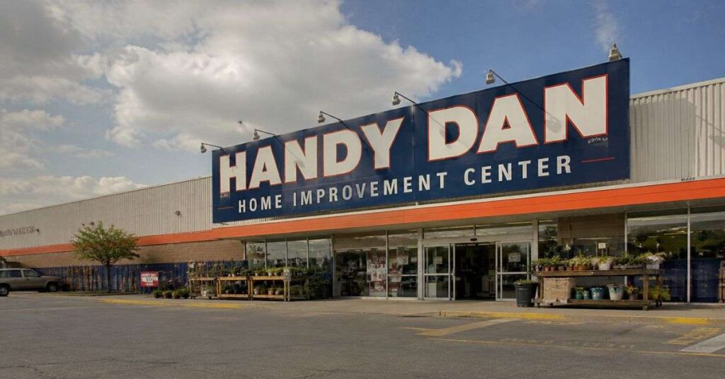 Vintage Handy Dan Home Improvement store exterior with large sign, parking area, and natural daylight view.